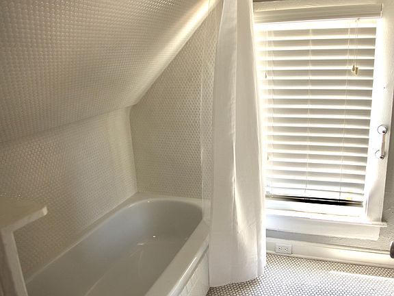 Upstairs bathroom with tub