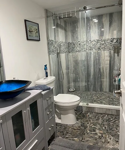 bathroom near kitchen and living room. large shower with Rain showerhead and radiant heat floor.