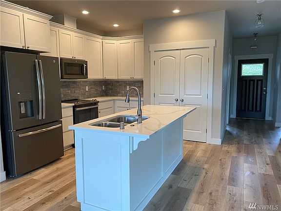 Photo of builder's previous build and not exact of home under construction.