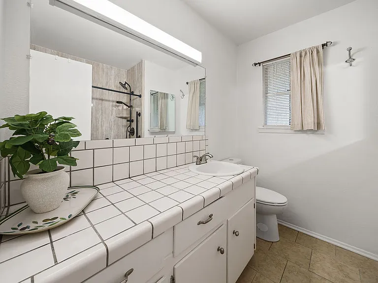 Main bathroom with updated luxury shower with bench