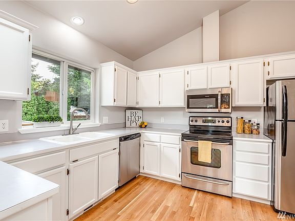 Bright white kitchen with stainless appliances