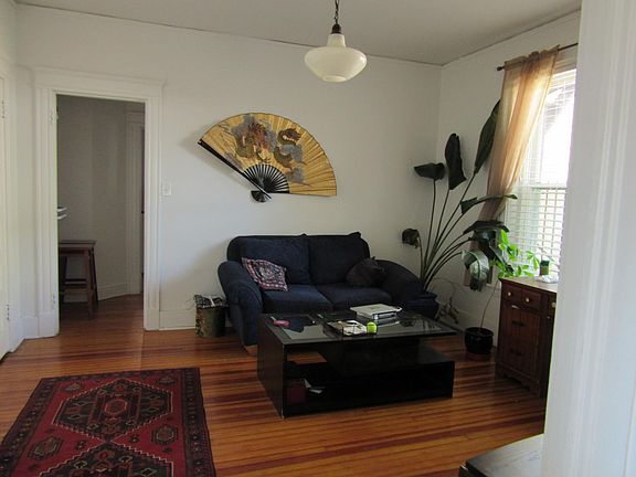 living room as furnished by former tenant.