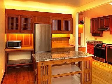 Large granite-topped island; dining area and south windows behind photog.