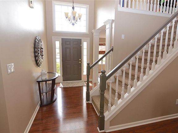 Dramatic 2-story entry with laminate hardwood flooring and decorative columns. New interior paint 2018. New stair carpeting 2018. New entry light 2010
