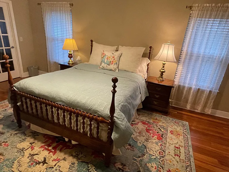 Twin reading light on nightstands adjoin the Queen sized bed.