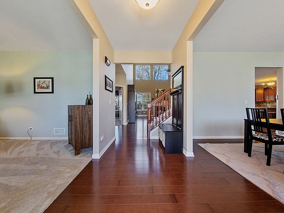 Gleaming hardwood floors lead you to formal living & dining rooms to the left & right. Straight ahea