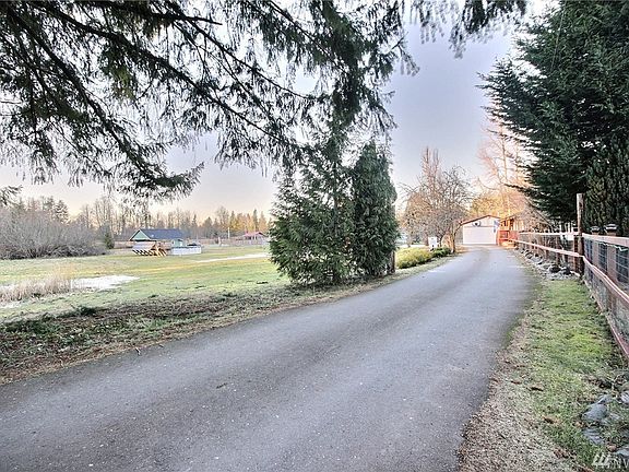 The entrance to the farm is lovely.  To the right of this photo is parking for employees, the backyard is fully fenced with a little firepit area.  Currently there is an above ground, solar heated pool which would stay with the property.  It has a built in deck around it also.