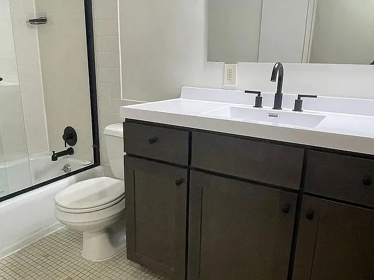 Elevate your lifestyle at LS Capital Group with this modern bathroom featuring sleek finishes and ample storage. Enjoy the perfect blend of comfort and functionality. Schedule your tour today to see all that awaits!