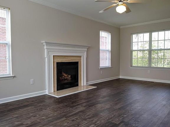 The spacious living room features a gas fireplace.