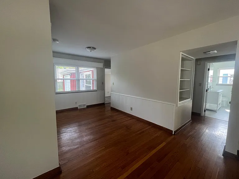 Dining area to first floor full bath and 2 bedrooms. 2 built-in hall cabinets, shelves and closet.