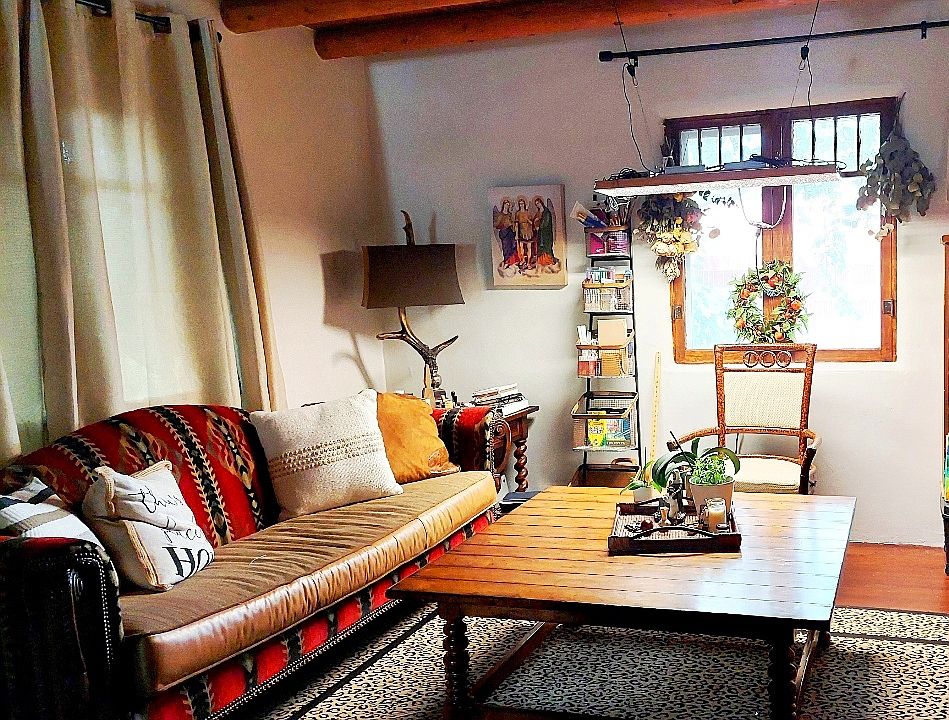 The Livingroom combo is separated by a sunken Fireplace. This home has both recent window but kept the original wood frame window for character. Has all wooden flooring.