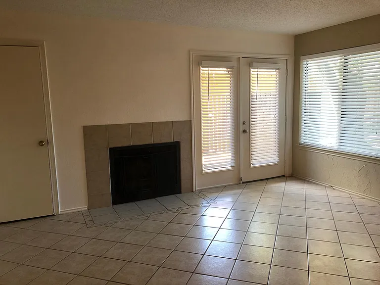 Entryway with fireplace and French doors.