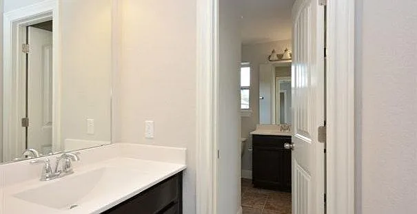 Attached bathroom for two bedrooms upstairs with an additional sink space outside