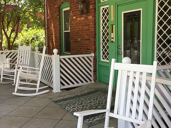 Large front porch with plenty of lounging opportunities for enjoying coffee in the morning sun.