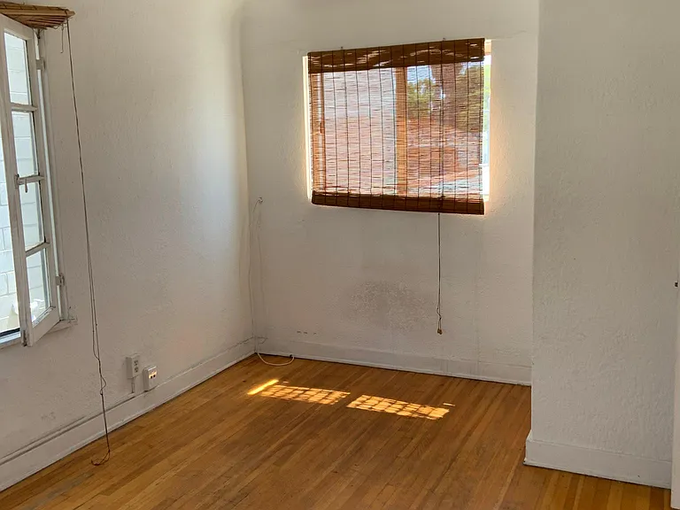 2nd floor bedroom with window facing south and window facing east on the left side