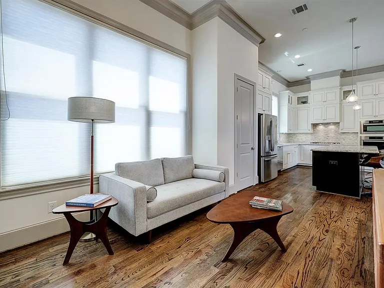 The dining area, currently setup as another living space, offers a fabulous 12 light Sputnik pendant light, art lighting, large storage closet (elevator capable), and oversized windows with cellular shades.