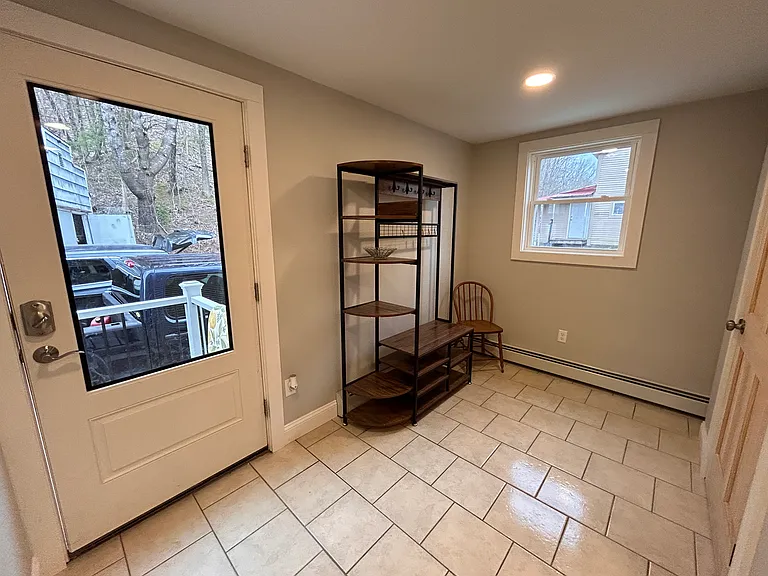 Mudroom with freestanding coat rack.