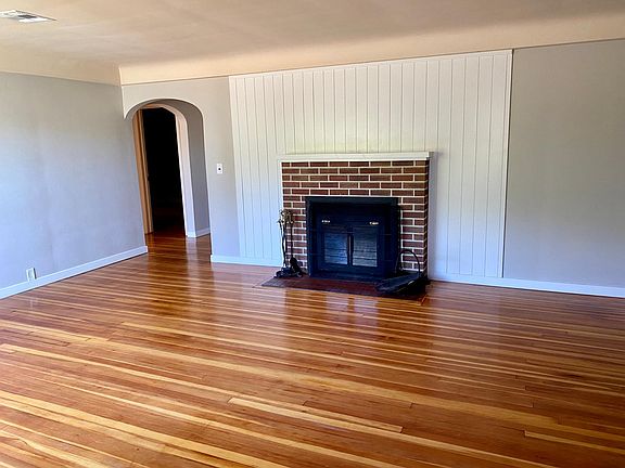 Living room. Fresh paint and refinished original wood floors.