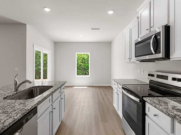 The kitchen leads to the dining area