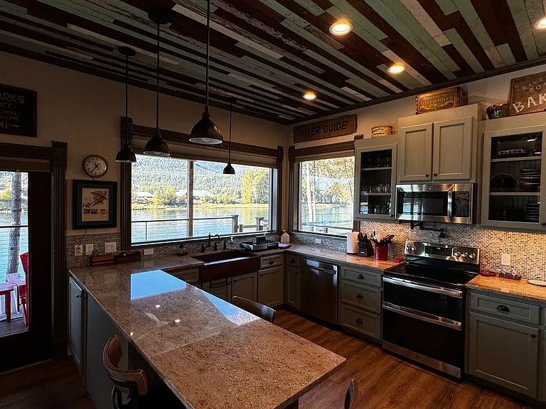 Spacious kitchen with granite countertops, stainless steel appliances. Incredible mountain and river views.