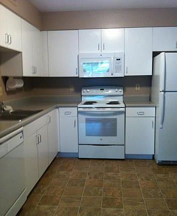 Eat in Kitchen with double stainless sink, dishwasher, garbage disposal, new built in microwave, new stove.