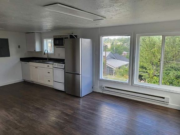 A little room with new flooring and Big windows above the neighborhood.
