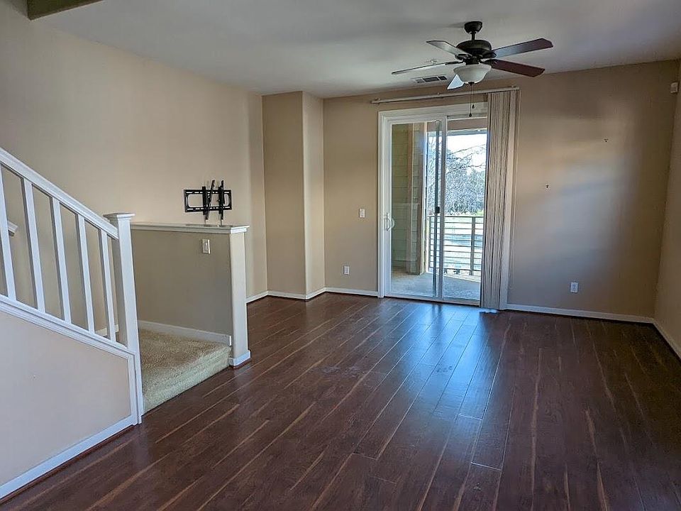 Living cum dining room with balcony and stairs leading to 3rd level