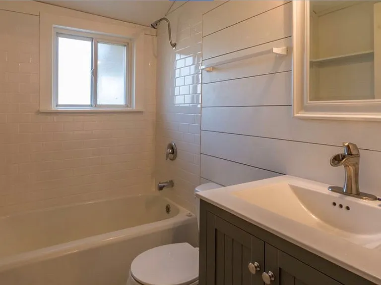 Tile shower, tile floor, shiplap walls