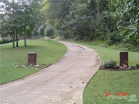 Winding concrete drive leads to this all brick contemporary home with east sun exposure for those "s