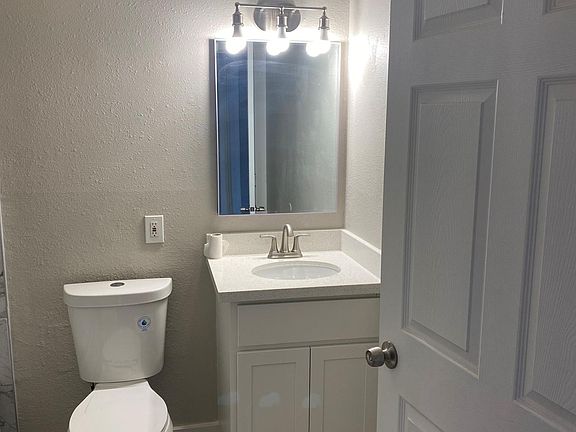 Second bathroom, new toilet, new shower, new granite counter, new cabinets, new sinks, new light fixtures