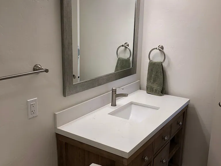 Master Bathroom with marble vanity top, large mirror and plenty of light.