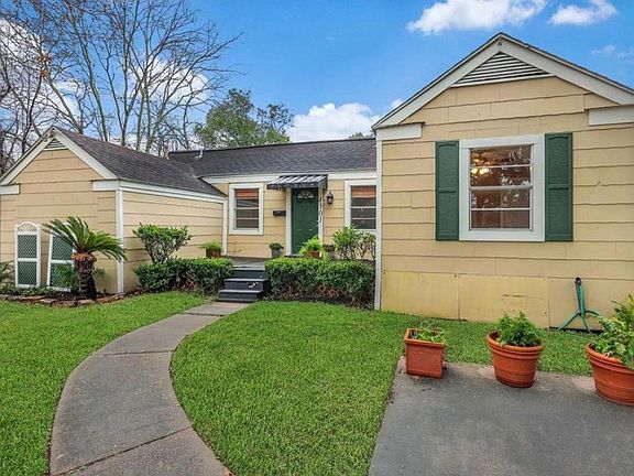 Professionally landscaped and front deck has railings now