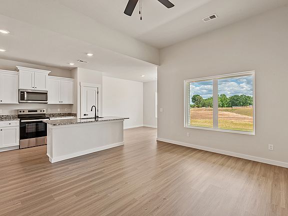 The kitchen has designer wood cabinetry