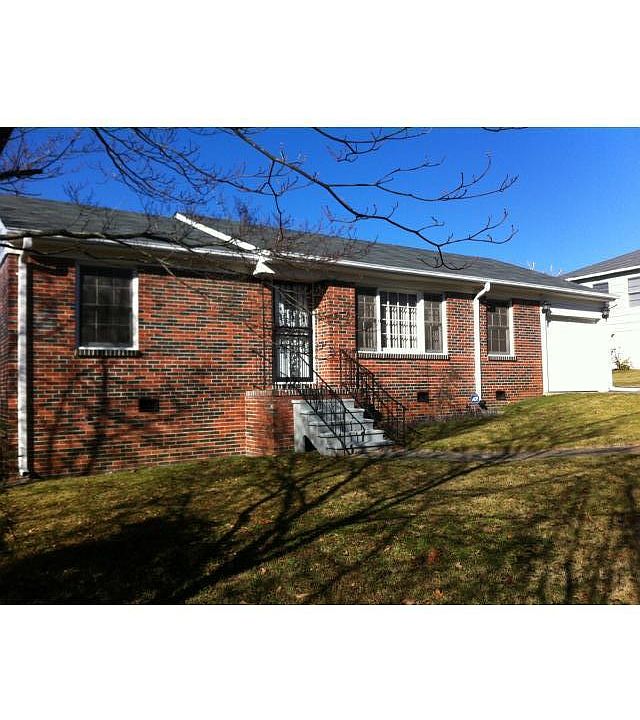 Front of house with beautiful wrought iron security door with flowers in front yard