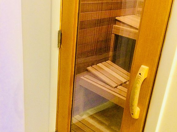 Two level sauna with stones and steam heat.