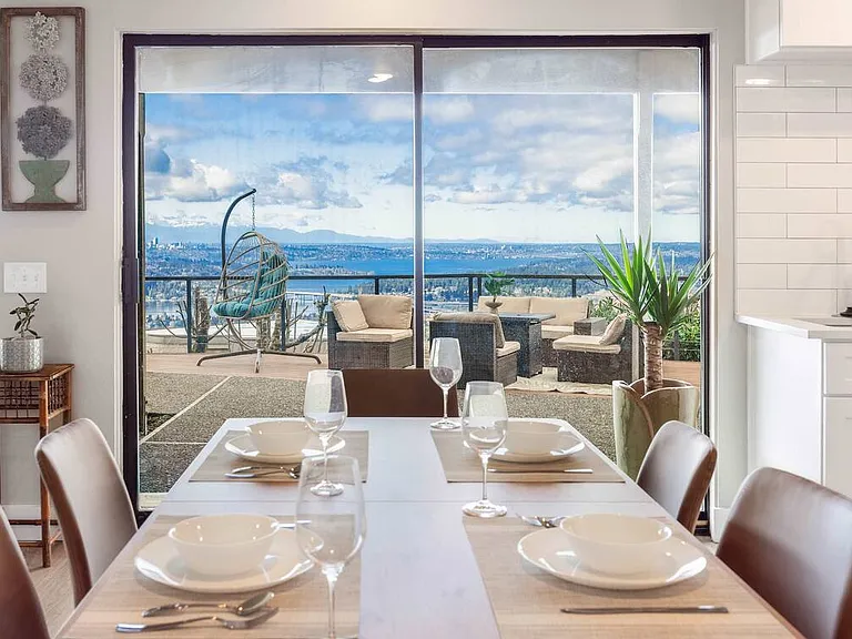 Enjoy meals in this cozy dining nook next to the sliding glass doors,leading to a spacious deck with breathtaking views-perfect for morning coffee and meals.