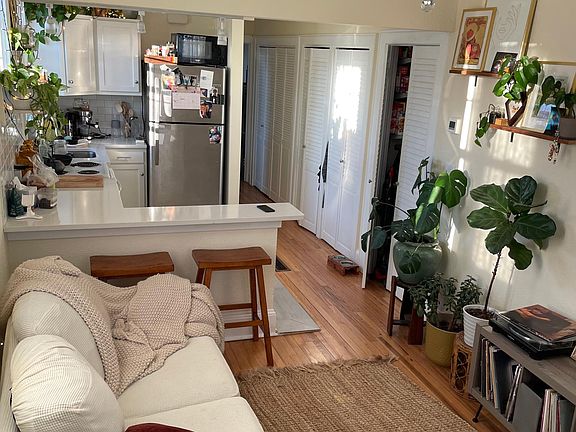 Front room, different angle looking back towards kitchen. Hallway closets in view.