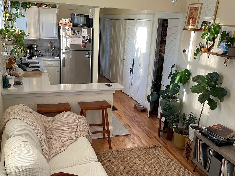Front room, different angle looking back towards kitchen. Hallway closets in view.