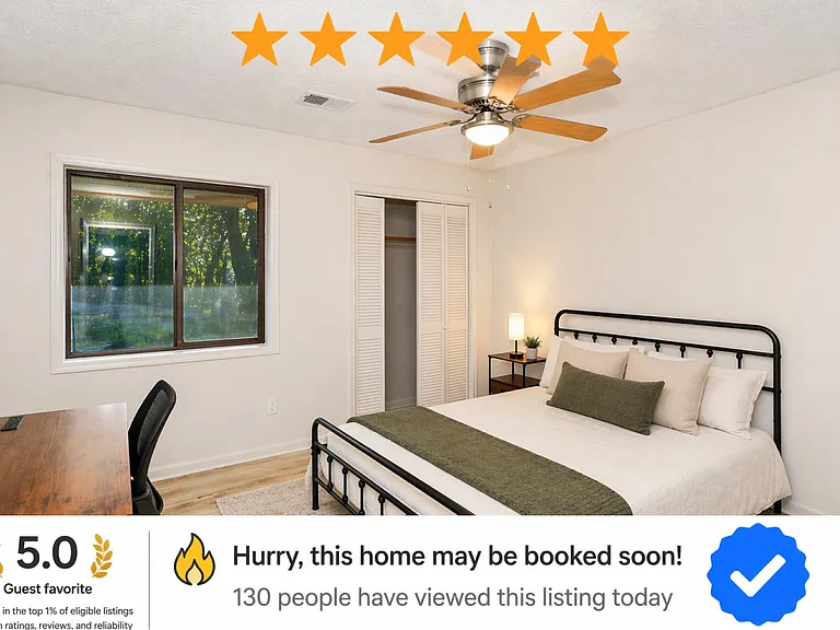 Bedroom with queen bed, ceiling fan, desk area, and sliding closet plus a large window with treetop views.