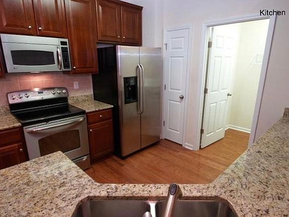 Laundry room off kitchen with washer/dryer included. Stainless steel appliances, granite countertops, cherry wood cabinets.