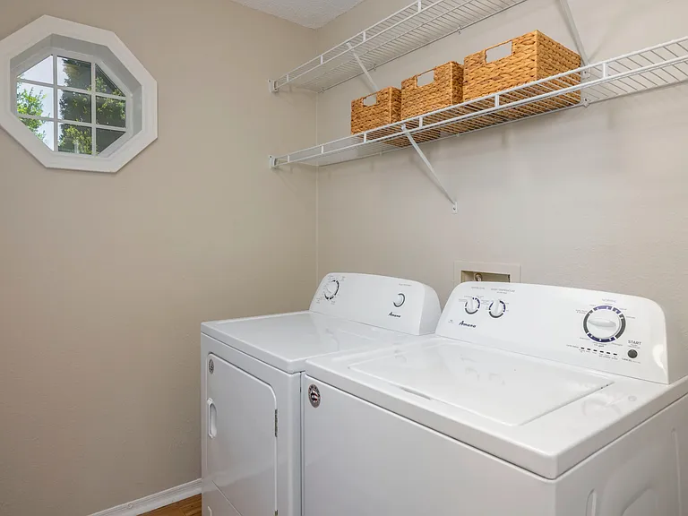 Feel the Laundry Room Vibe: Full-Size Washer, Dryer, and Ample Storage with Cheerful Natural Light, Making Laundry a Breeze!