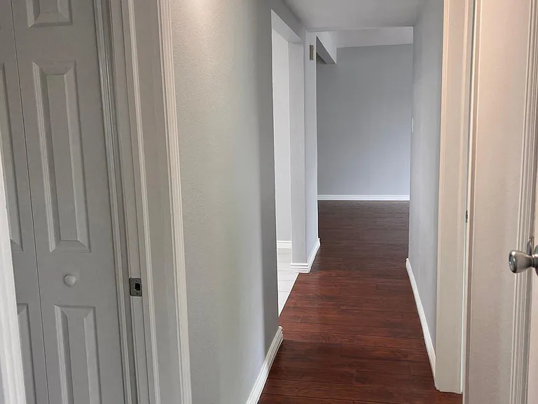 hallway looking back toward kitchen/living room/dining room