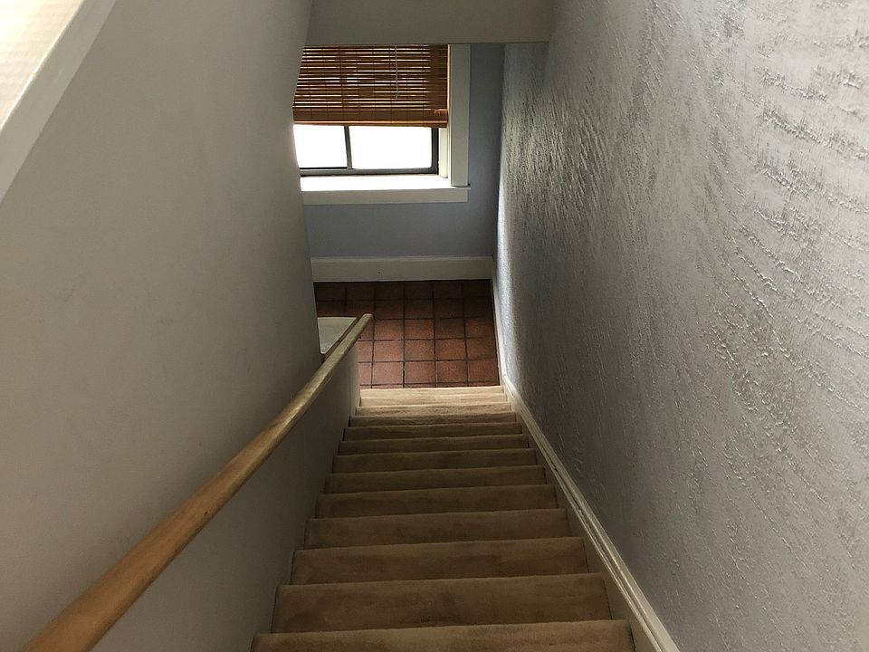 Carpeted internal stairs lead to the 3rd floor, where this special apartment unfolds.