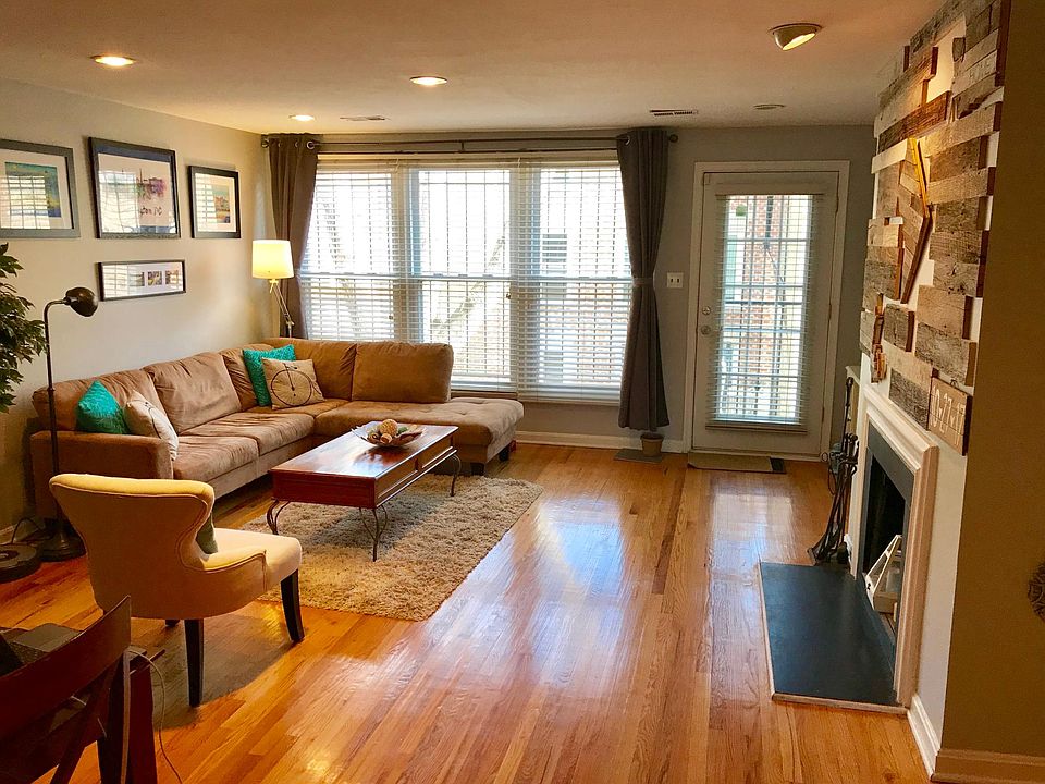 The expansive open-concept living and dining room has plenty of space to make this your home. Featuring a decorative fireplace, there's room for one or two couches, a full-size dining table, and an extra deep closet for storage. The stairs near the window