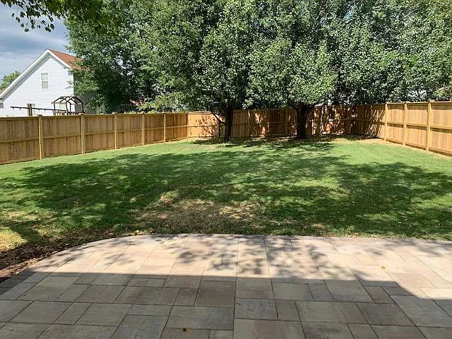 Back yard with new fence