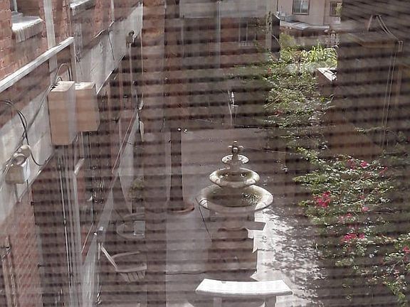 OUTSIDE COURTYARD WITH FOUNTAIN ON SIDE OF BUILDING