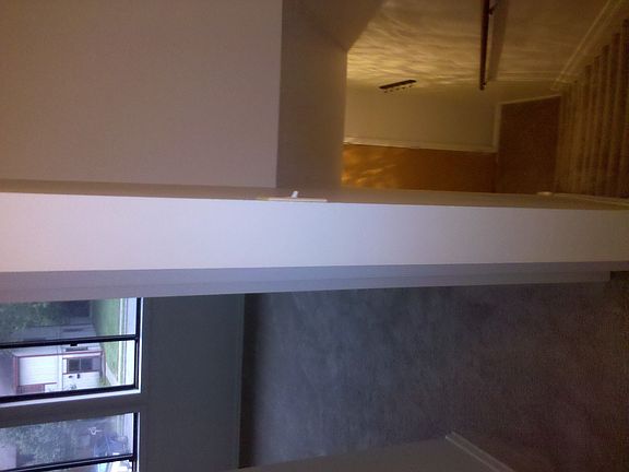 top of the stairs looking at master bedroom and front door.