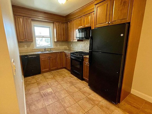 Kitchen Area, Granite Counters, Custom Wood Cabinets. Stone Tile floors