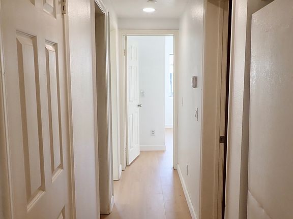 Hallway to bathroom, laundry room and bedrooms