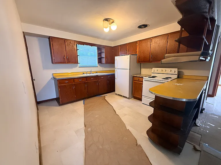 Kitchen with protective paper on new tile floor